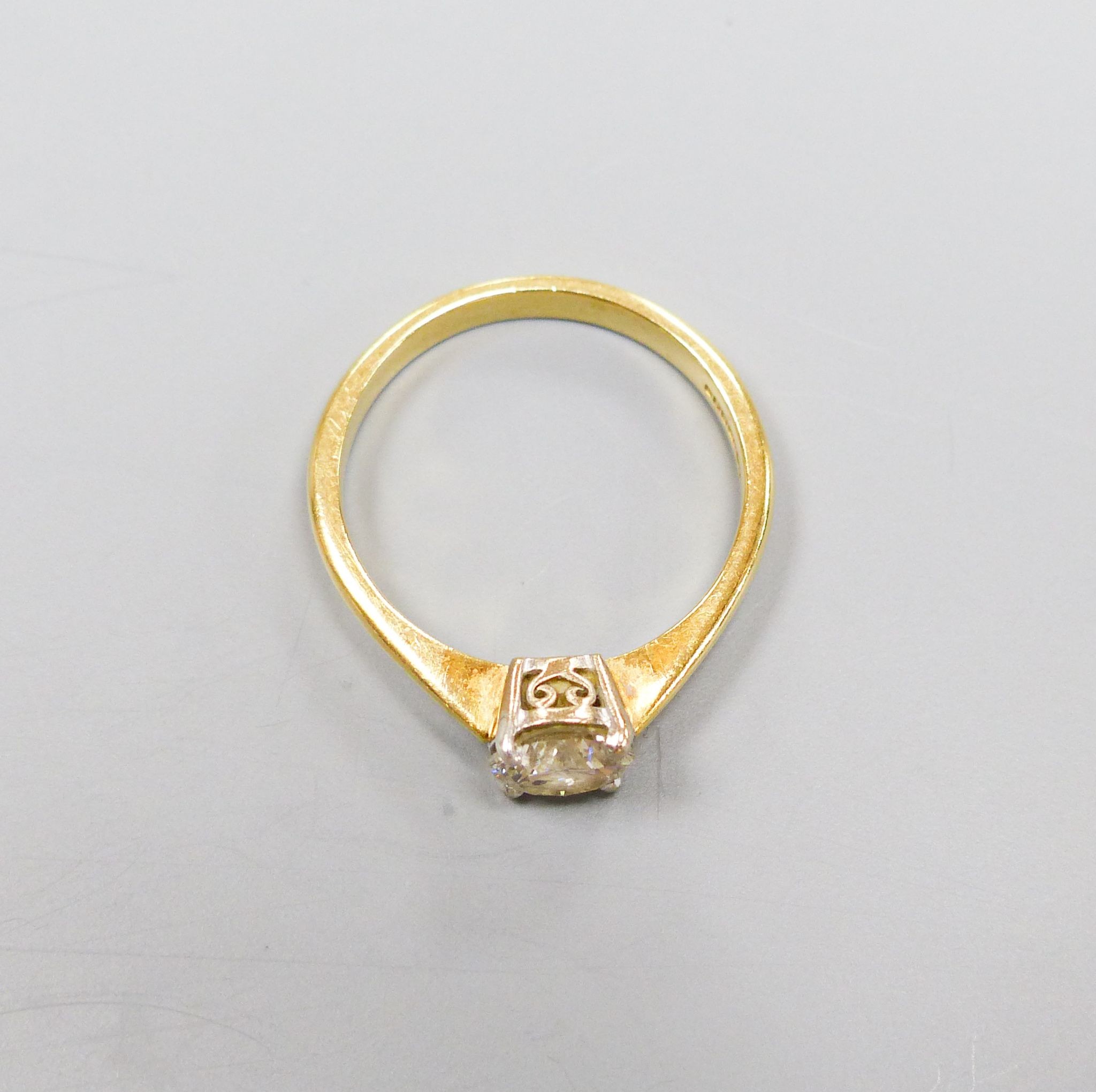 A modern 18ct gold and solitaire diamond ring, size O, gross 3.2 grams